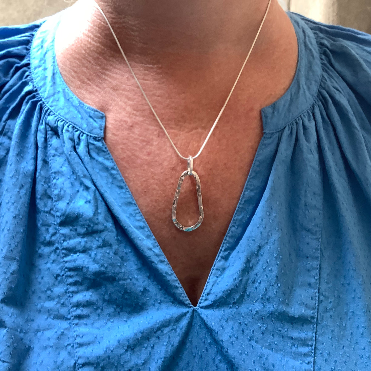 Sterling silver hammered squashed oval pendant